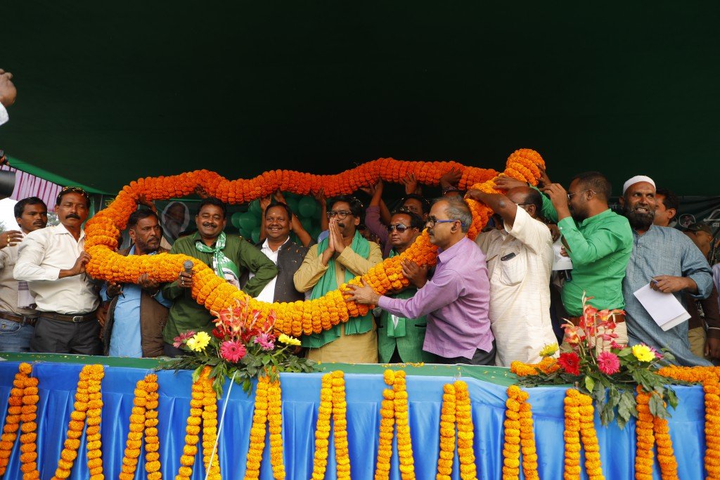 Party workers and leaders at a felicitation ceremony on stage